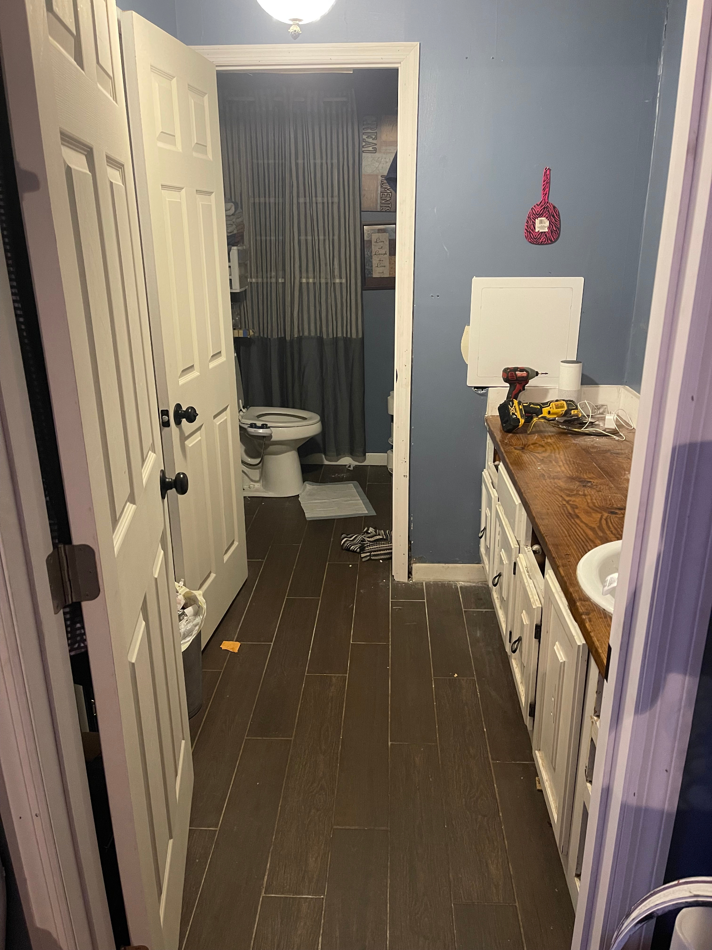Before - hallway view into bathroom with old vanity - Cleveland, TN