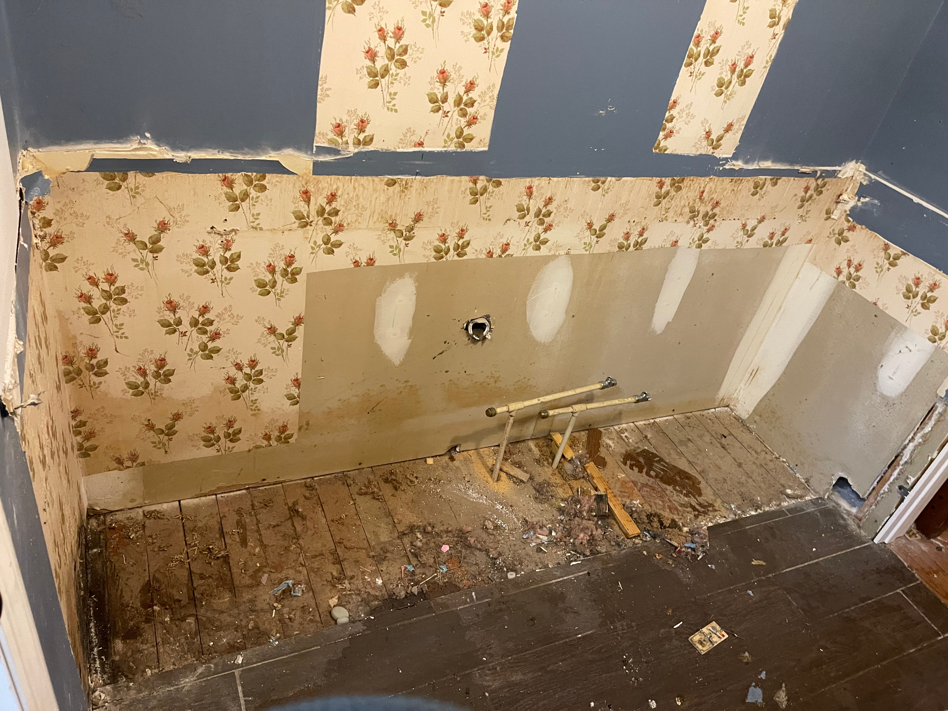 Demo - exposed wall with plumbing and debris - Cleveland, TN