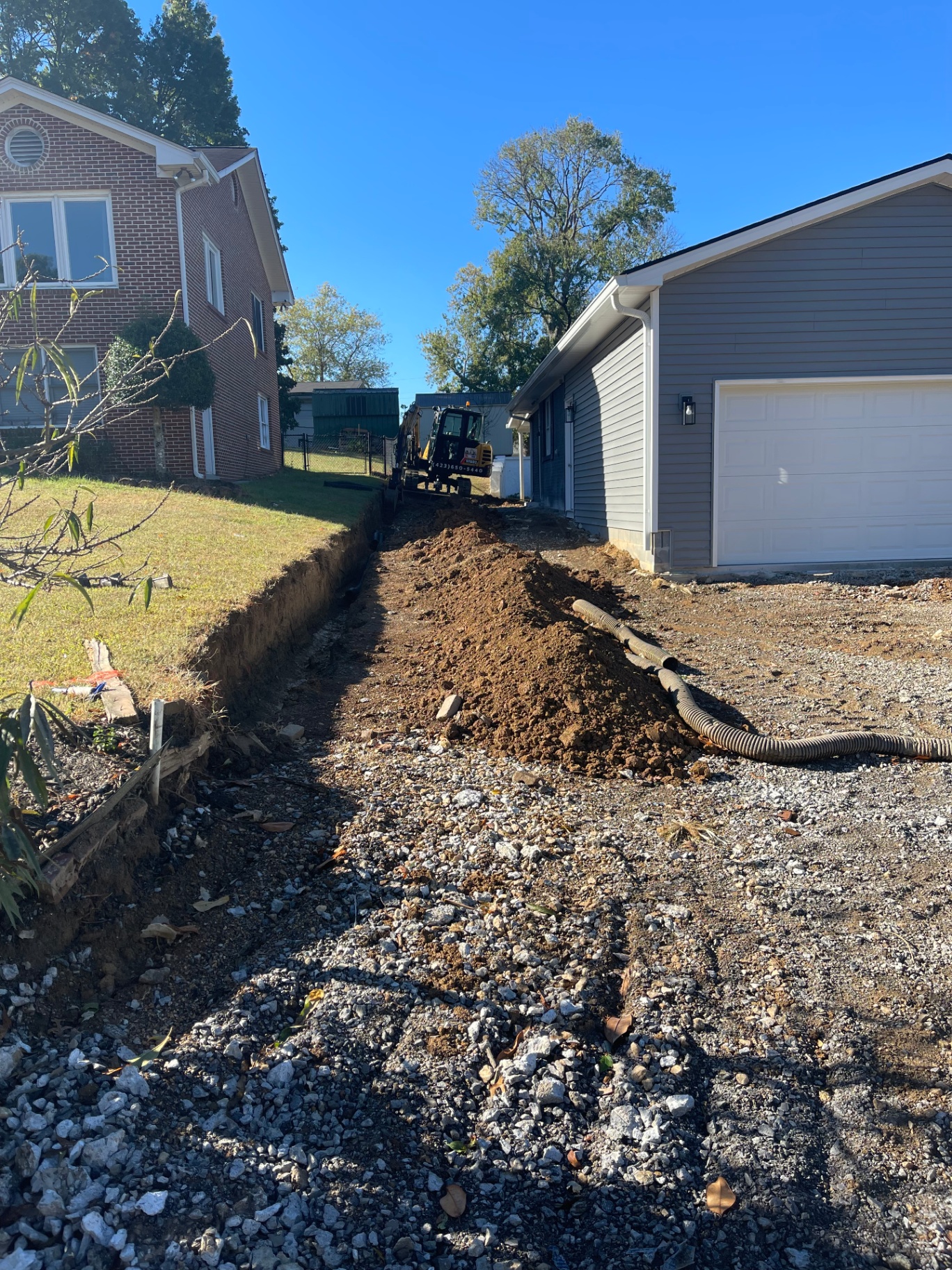 Drainage excavation between house and garage - Cleveland, TN