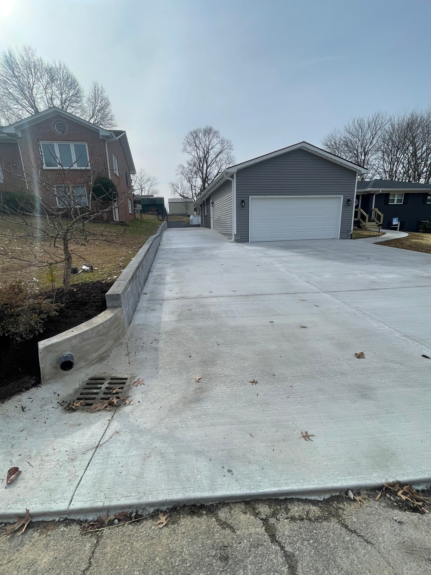 Completed driveway with retaining wall and drain - Cleveland, TN