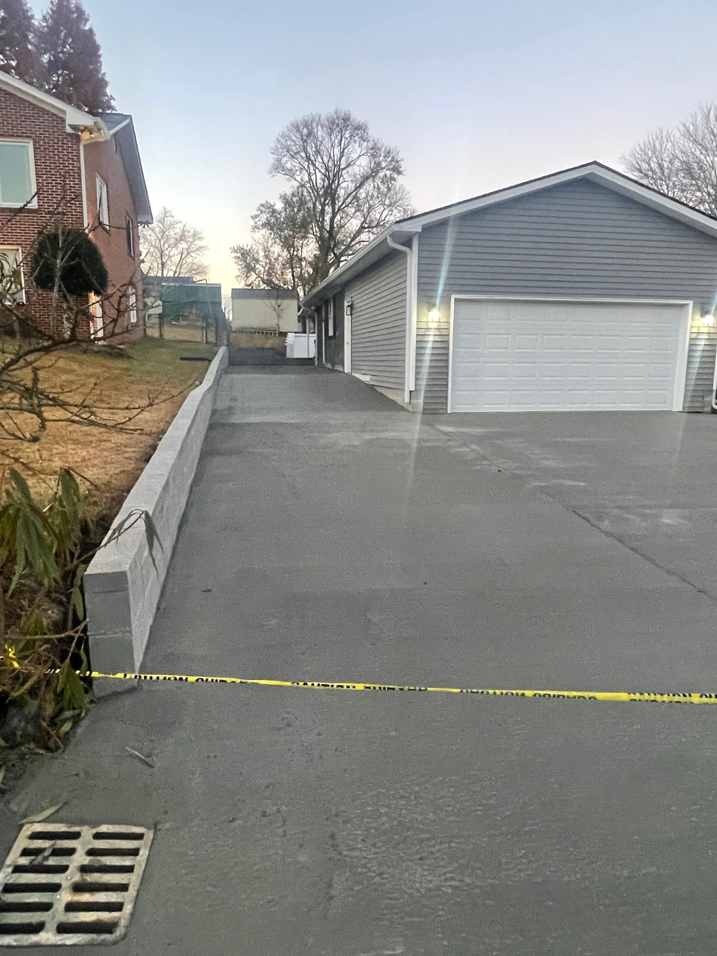 Fresh concrete driveway - retaining wall and garage - Cleveland, TN