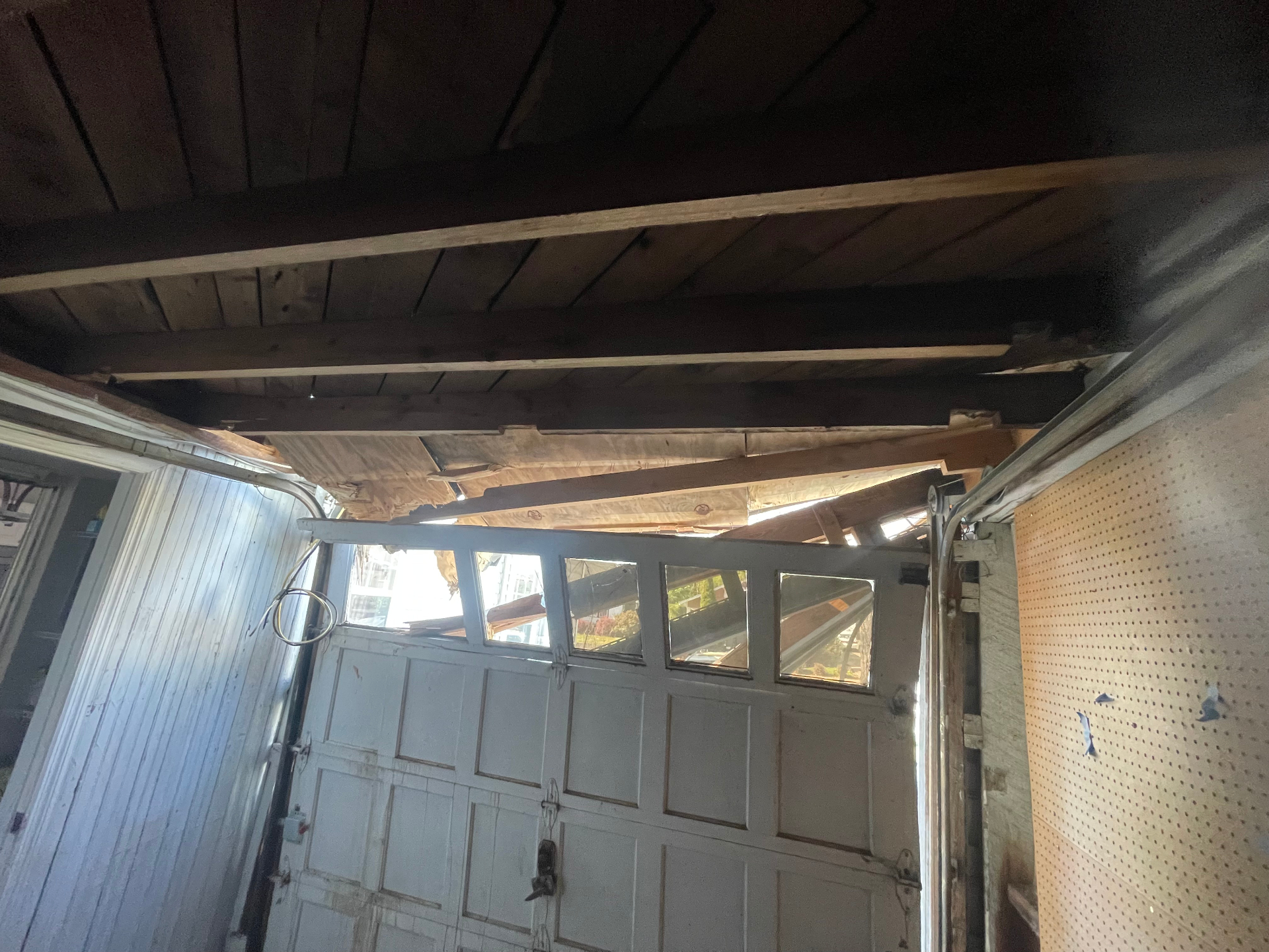 Original garage door and damaged roof - Cleveland, TN