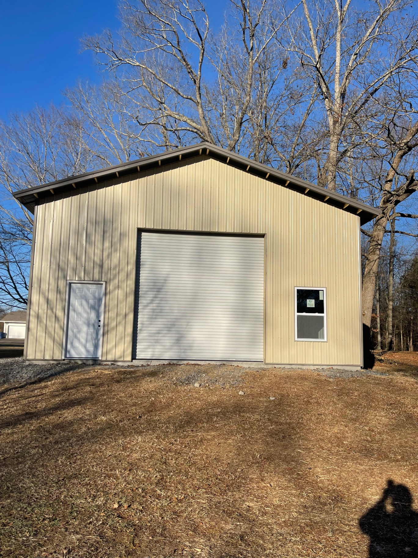 Finished exterior - tan metal siding with white trim - Cleveland, TN