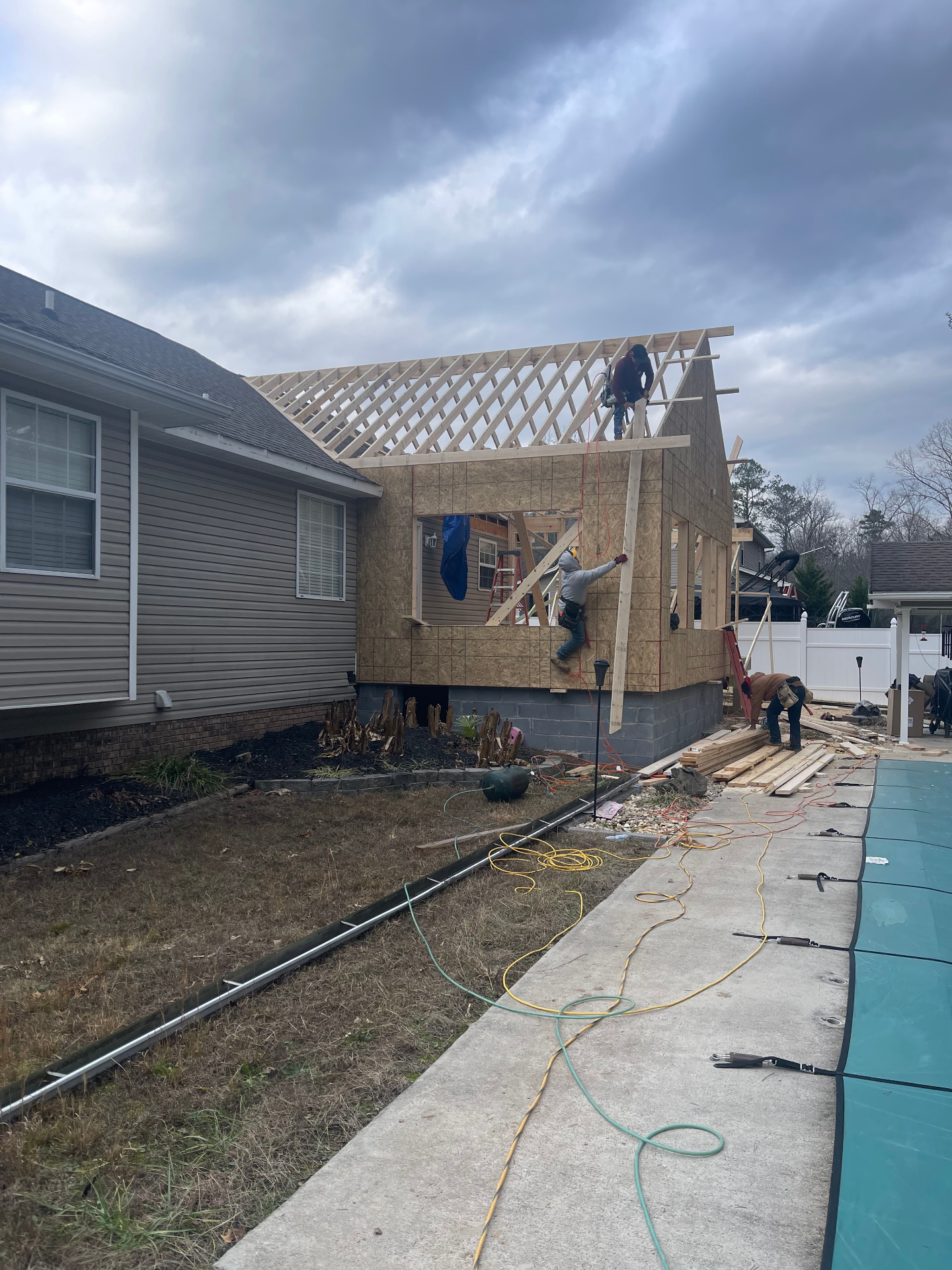 Roof trusses and sheathing going up on addition - Cleveland, TN